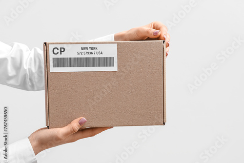 Woman holding cardboard pac...