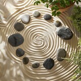 Zen Garden Circle: Arrange smooth sea stones in a circular pattern within a sand or gravel base to create a serene and meditative Zen garden. Incorporate raked patterns in the surrounding sand.
