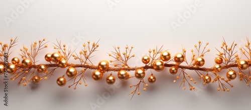 concept Garland made of gold balls and fir tree branches on a white background. Flat lay  copy space