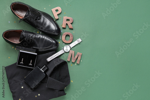 Word PROM with male shoes, shirt and cufflinks on green background