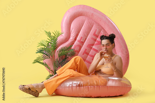 Young woman holding cocktai...