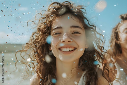 Girls with curly brown hair in their teens smiling and tossing confetti outdoors on a sunny day. Concept Teen Photoshoot, Curly Brown Hair, Confetti Toss, Sunny Day, Joyful Portraits photo