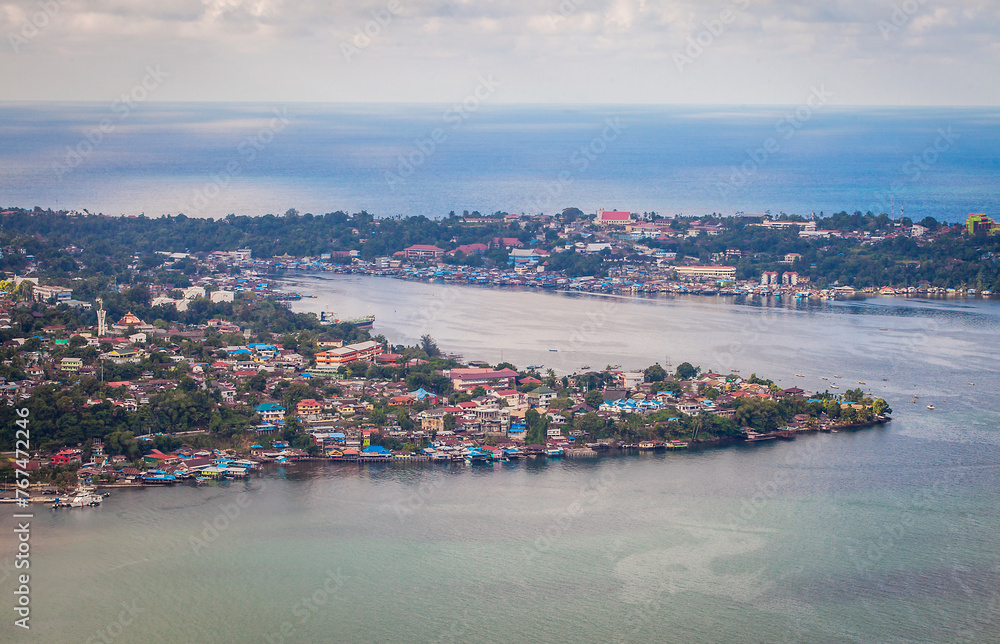 Residential housing on the coast of small islands in the waters of Youtefa Bay in Jayapura City, Papua, Indonesia.