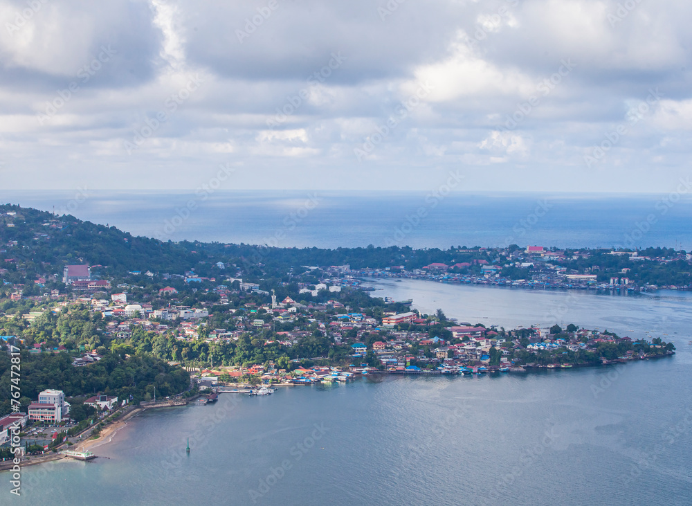 Residential housing on the coast of small islands in the waters of Youtefa Bay in Jayapura City, Papua, Indonesia.