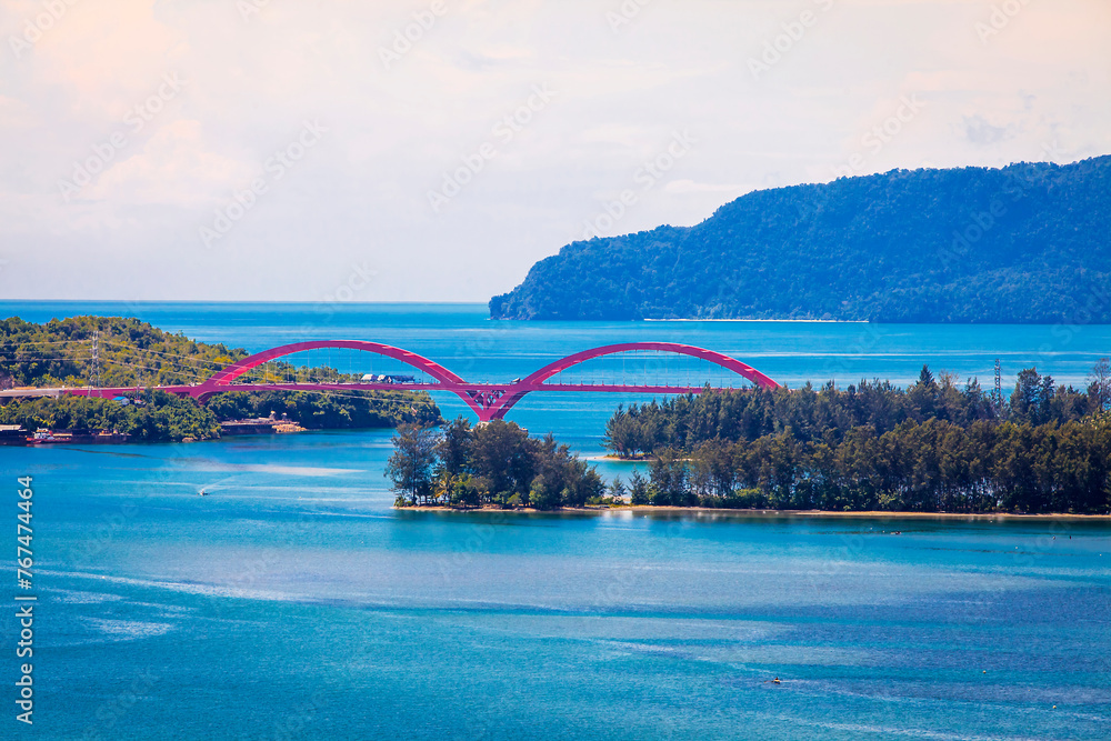 Beautiful View of Youtefa Bay with Red Bridge in Jayapura, Papua, Indonesia. The Youtefa Bridge or known to the people of Jayapura as the Red Bridge is one of the grandest bridges in Papua. Beautiful View of Youtefa Bay with Red Bridge in Jayapura, Papua, Indonesia. The Youtefa Bridge or known to the people of Jayapura as the Red Bridge is one of the grandest bridges in Papua.