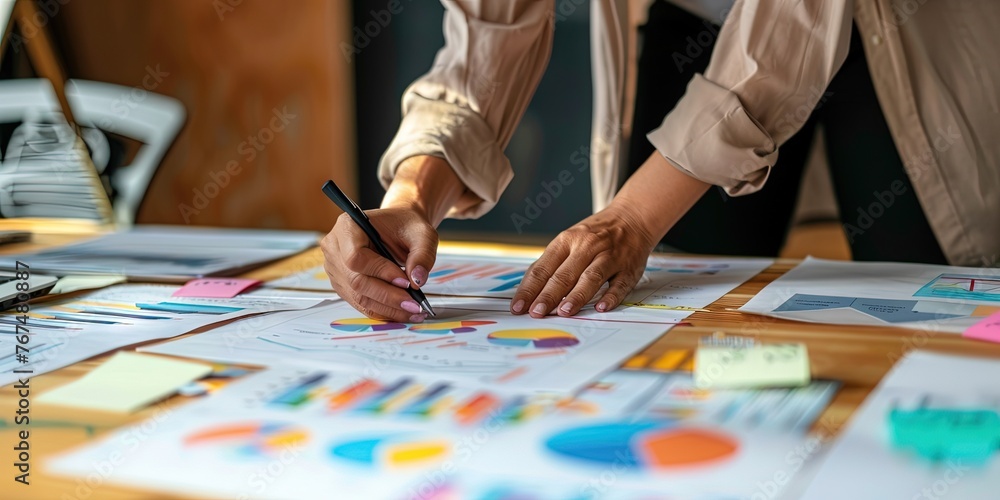 Office worker checking statistics and charts to track key performance indicators (KPI) Office worker checking statistics and charts to track key performance indicators (KPI)