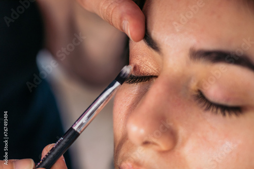 Close-up of a woman having her eyes made up