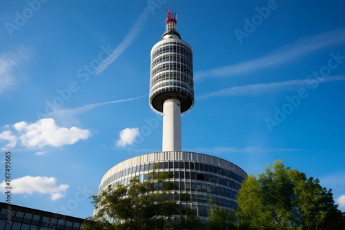 An Iconic View of the BT Tower Amid the Bustling London Skyline Under Clear Blue Sky photo