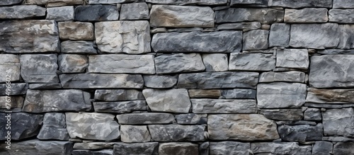 A detailed closeup of a brickwork stone wall showcasing a beautiful pattern of rectangular bricks, made of composite material and set on a bedrock foundation