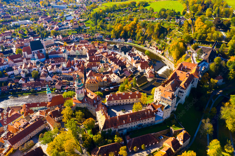 View from drone of historical houses of Czech city Cesky Krumlov in sunny fall day