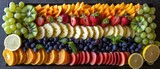 An exotic fruit platter arranged to resemble a tropical sunset with layers of colors and textures