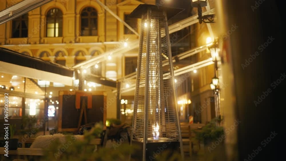 At midnight, a large heater stands in front of a building At midnight, a large heater stands in front of a building