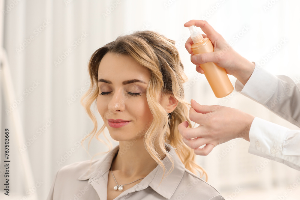 Fototapeta premium Hair styling. Professional hairdresser working with client indoors, closeup