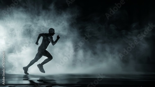 Athlete running on a black background in smoke