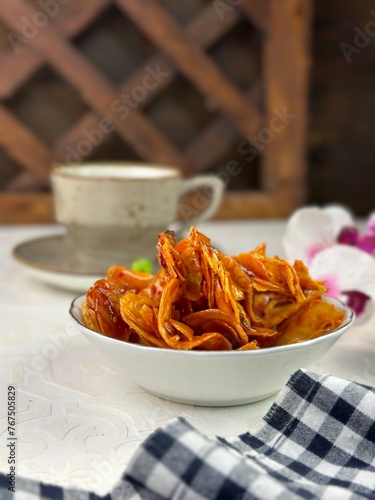 A Malay traditional snack named Kerepek Ubi Pedas Basah. This is local Asian junk food dried and fried cassava slices. photo