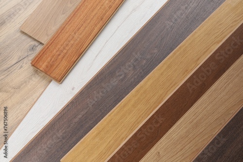 Different samples of wooden flooring as background  top view