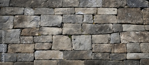 A detailed shot of a stone wall made up of bricks showcasing the intricate pattern and durable composite material used in building construction
