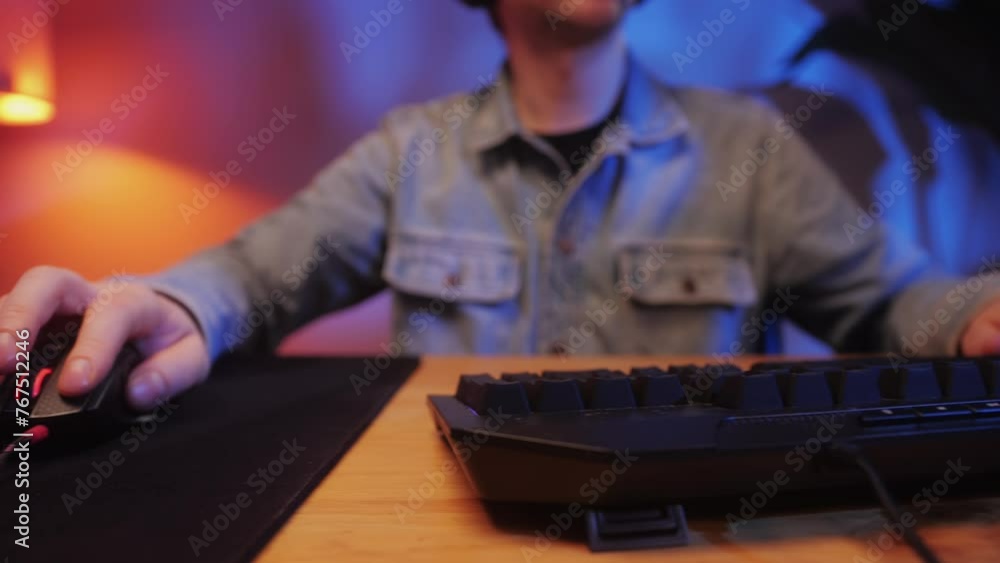 Gamer man typing on backlight keyboard close-up, man playing video game . Male hands pushing buttons on computer mouse. having a stream, cyberspace. Gamer man typing on backlight keyboard close-up, man playing video game . Male hands pushing buttons on computer mouse. having a stream, cyberspace.