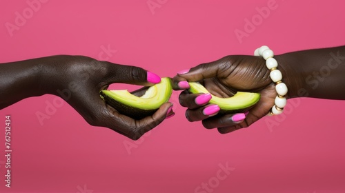  a close up of a person holding a piece of fruit with another person holding a piece of fruit in their hand. © Olga