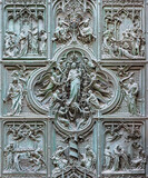 MILAN, ITALY - SEPTEMBER 16, 2024: The detail from main bronze gate of the Cathedral - Virgin Mary with the angels by Ludovico Pogliaghi (1906).