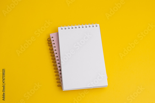 Notebook with a wish list to-do list on yellow background, flat lay style. Planning concept. (ID: 767518021)