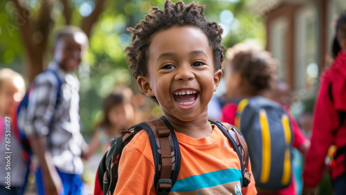 Portrait of happy african american schoolboy with backpack at school