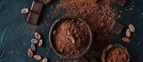 Cocoa and cacao idea illustrated with cocoa powder in a bowl, cocoa beans, and crushed chocolate on a dark surface.