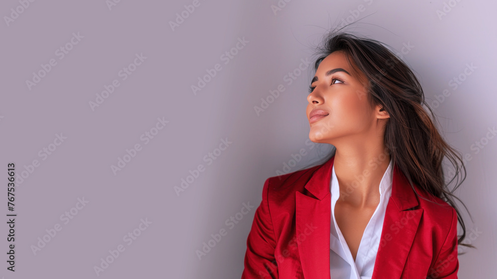 Indian businesswoman wearing red formal suit, smiling side view Indian businesswoman wearing red formal suit, smiling side view