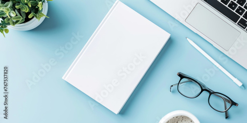 top view white book and accounting on a minimal clean light blue desk with laptop