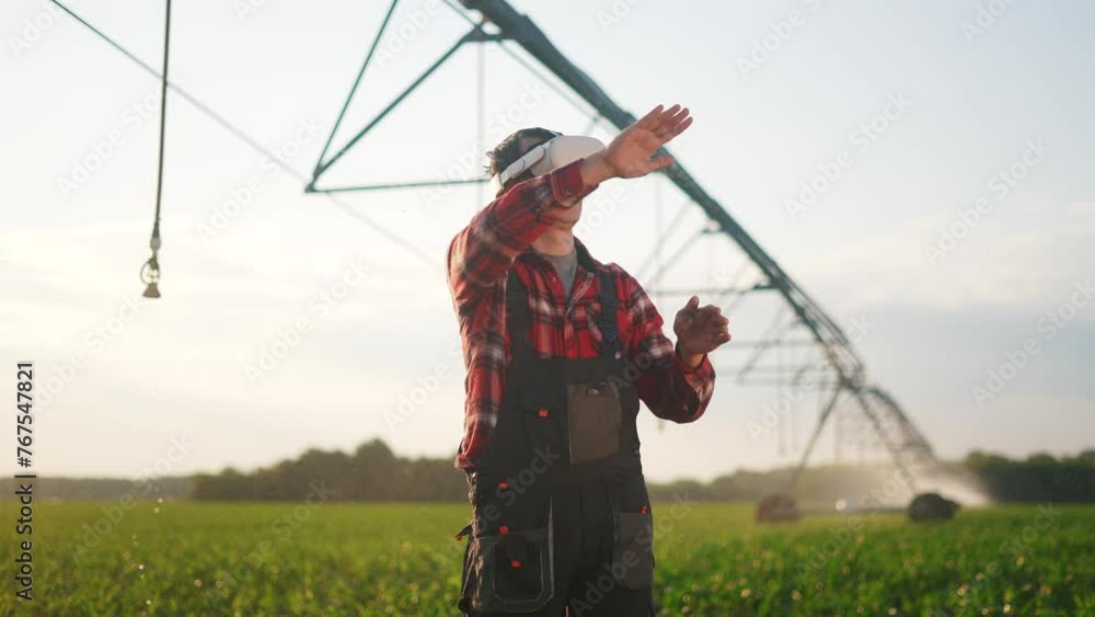 agriculture virtual reality. a farmer in virtual reality glasses controls a machine to irrigate corn field. agriculture virtual reality concept. a farmer vr in works in field with corn business agriculture virtual reality. a farmer in virtual reality glasses controls a machine to irrigate corn field. agriculture virtual reality concept. a farmer vr in works in field with corn business
