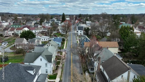 Homes and Buildings in Residential Area of USA. Sunny day on Main Street of small town. Aerial Birds Eye shot.