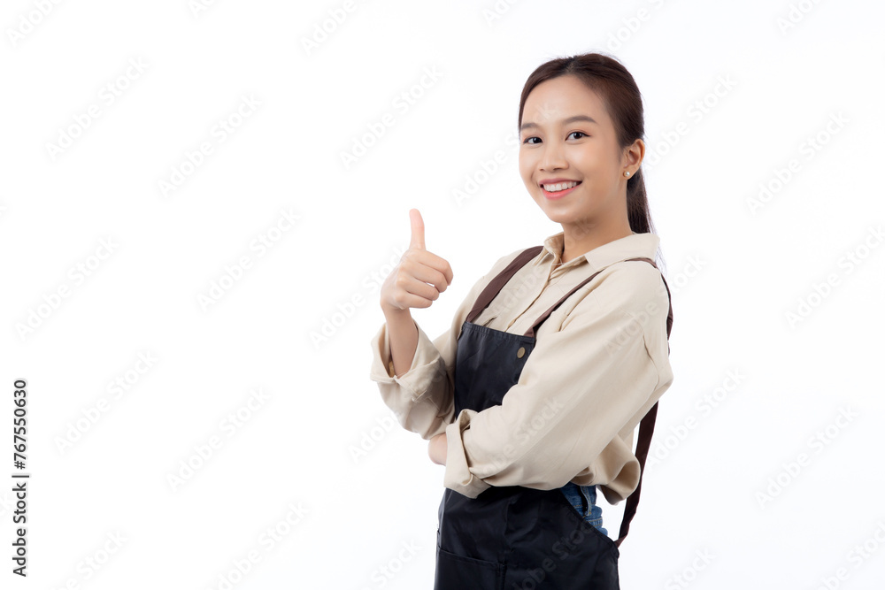 Portrait smiling young asian woman wearing apron showing thumbs up with hand isolated white background, young asian woman making thumbs up gesture, waitress or entrepreneur, small business or startup. Portrait smiling young asian woman wearing apron showing thumbs up with hand isolated white background, young asian woman making thumbs up gesture, waitress or entrepreneur, small business or startup.