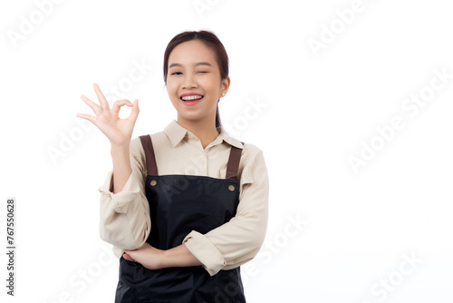 Portrait smiling young asian woman wearing apron showing ok sign with hand isolated white background, young asian woman making okay gesture, waitress or entrepreneur, small business or startup.