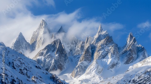 The jagged peaks of a snowcovered mountain range stand as a stark contrast to the smooth undulating form of the cascading avalanche.