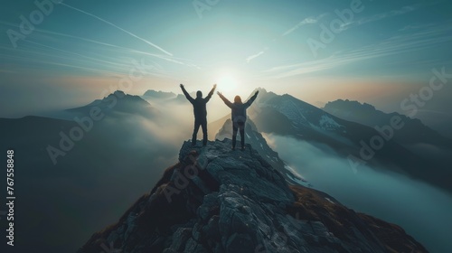 Together overcoming obstacles with three people holding hands up in the air on mountain top   celebrating success and achievements