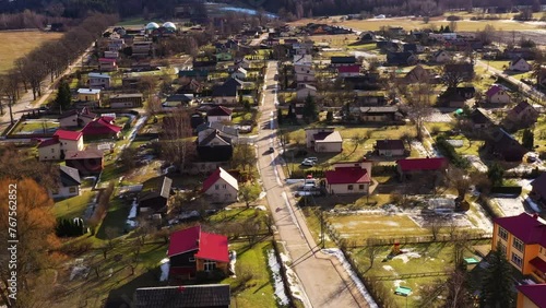 Koceni parish with long shadows from trees and slanted roofs iconic to Latvia photo