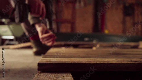 Person Using Cordless Screw Driver On Woodwork Carpentry Inside The Shop. Rack Focus Shot photo