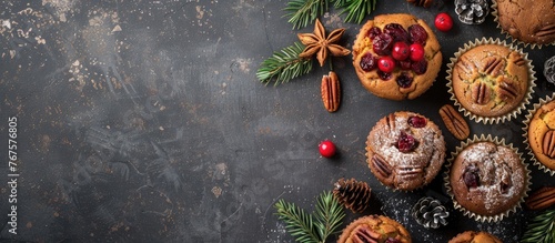 Cranberry and pecan nut cakes and muffins with Christmas decor, viewed from above with space for text.