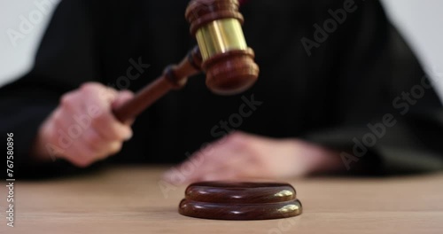 Competent judge taps gavel signaling for order in courtroom