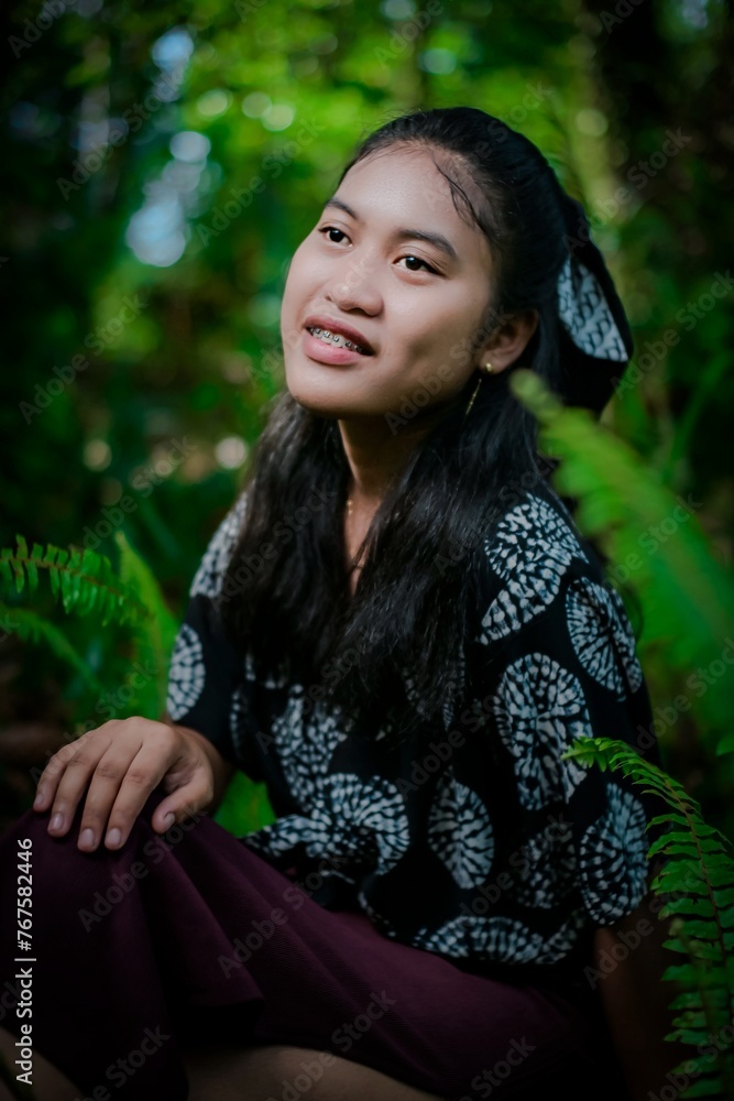 Young girl model with typical Indonesian face in the park Young girl model with typical Indonesian face in the park