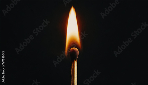 Match with fire lit, flame, black background, close-up