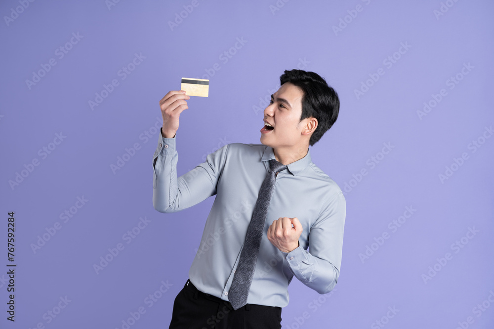 Portrait of Asian male businessman posing on purple background Portrait of Asian male businessman posing on purple background