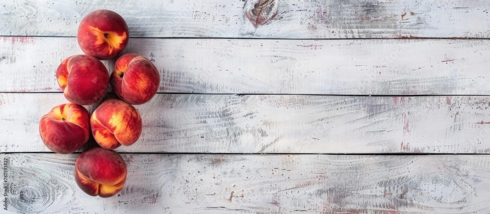 Peaches on a white wooden surface, seen from above with space for text. Peaches on a white wooden surface, seen from above with space for text.