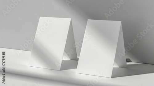 Two white cards with a triangle shape on them. The cards are placed on a table