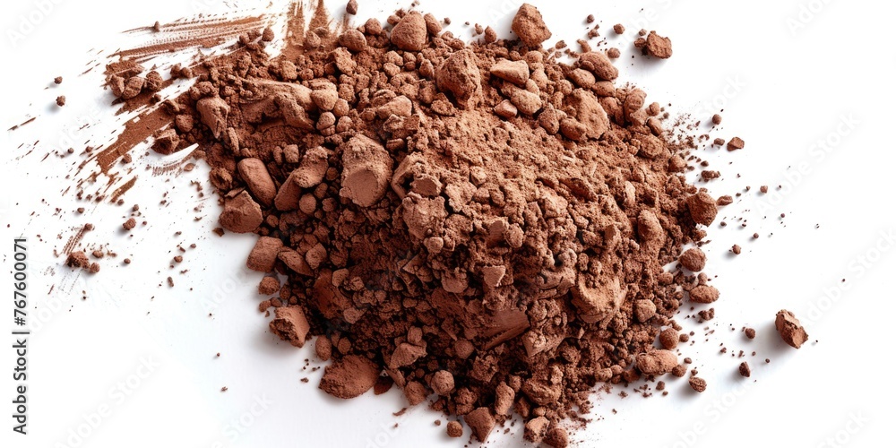 A pile of brown powder on a white background. The powder is likely a type of makeup or a cosmetic product. Concept of texture and depth, as the powder is spread out A pile of brown powder on a white background. The powder is likely a type of makeup or a cosmetic product. Concept of texture and depth, as the powder is spread out