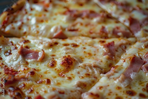 A slice of pizza with ham and cheese. The pizza is cut into two pieces