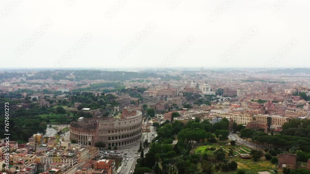 Aerial: Colosseum Surrounded By Streets And Buildings In City Against Sky - Rome, Italy Aerial: Colosseum Surrounded By Streets And Buildings In City Against Sky - Rome, Italy