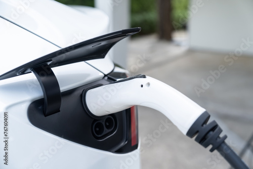 Electric vehicle technology utilized to residential area or home charging station for EV car battery recharge. Eco-friendly transport by clean and sustainable energy for future environment. Synchronos