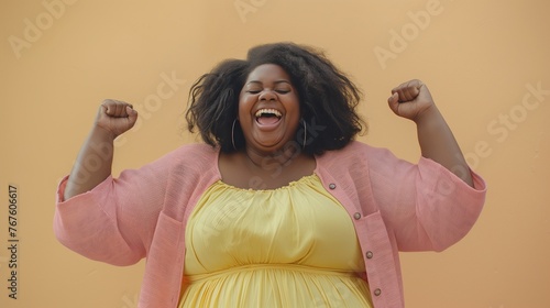 Happy overweight african american woman loves herself and accepts herself, body positivity. Win the lottery, get lucky photo
