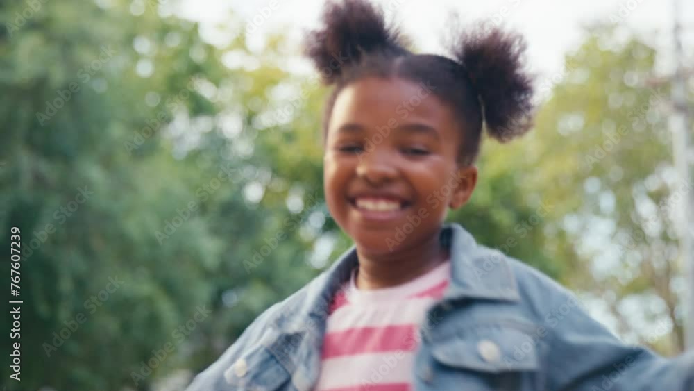 Smiling and laughing young girl playing outdoors in countryside or garden spinning around - shot in slow motion Smiling and laughing young girl playing outdoors in countryside or garden spinning around - shot in slow motion